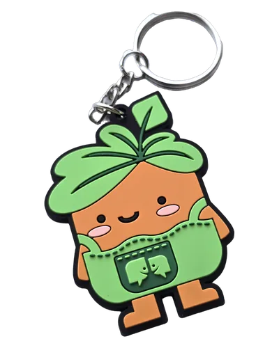 Portachiavi personalizzato in PVC 2D a mascotte arancione con capelli a foglie verdi e salopette, quattro colori a campitura piena e anello in metallo